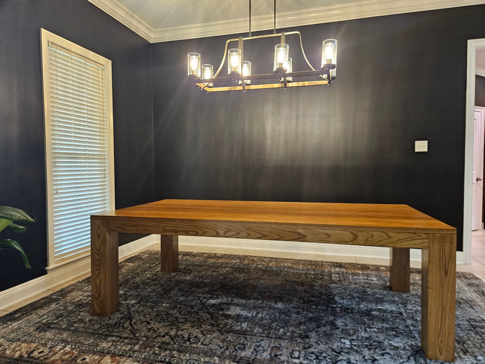A solid ash tabletop showing its grain under a hand-rubbed finish